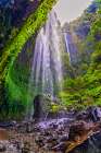 Indonesia. Tumpak Sewu waterfall flowing into a turquoise pool below. It is located near Lumajang. Art Print